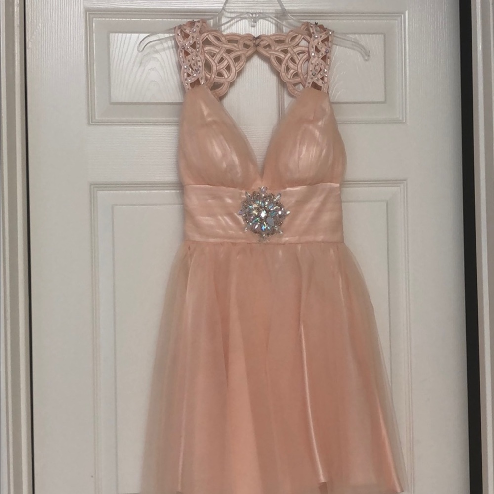 A blush pink dress with a low open back.